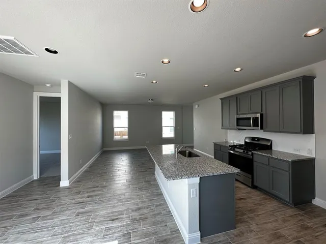 a view of kitchen with sink microwave and stove