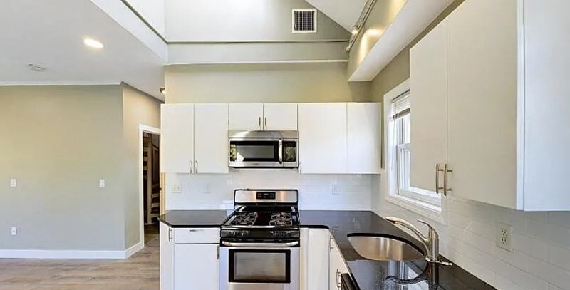 17 Ashley Street, Unit 3 Boston, MA 02130 - Photo 1 of 9 a kitchen with stainless steel appliances a stove a sink a microwave and cabinets