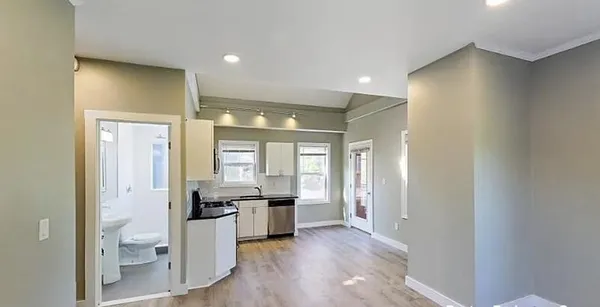 a open kitchen with white cabinets and stainless steel appliances