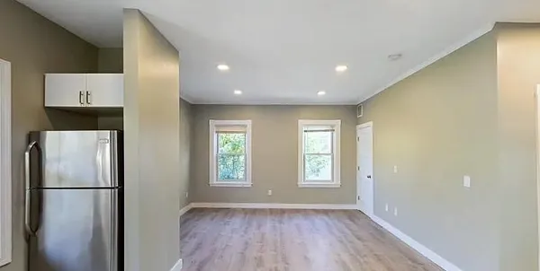 a view of kitchen with a refrigerator wooden floor and window