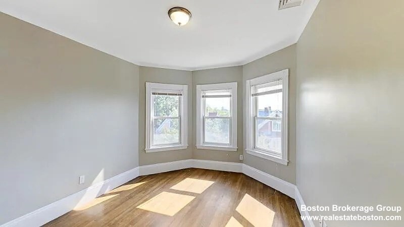 17 Ashley Street, Unit 3 Boston, MA 02130 - Photo 4 of 9 an empty room with windows