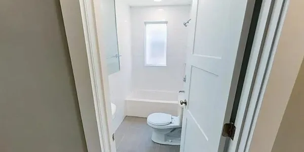 a bathroom with a sink mirror and shower