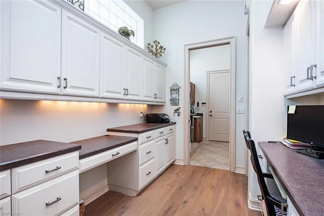 a kitchen with granite countertop white cabinets and white appliances