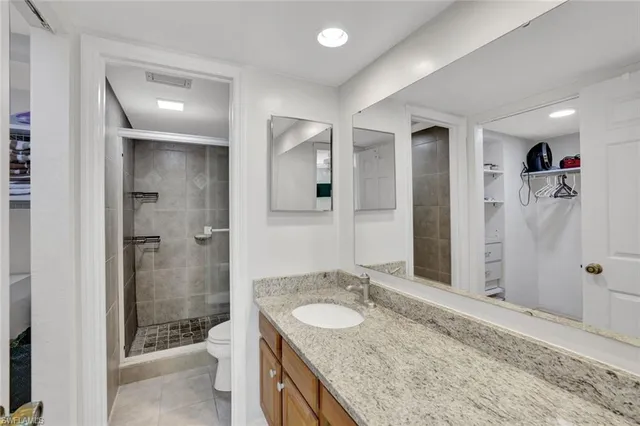 a bathroom with a granite countertop sink shower and a mirror