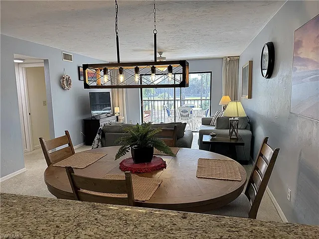 a living room with furniture a window and a table