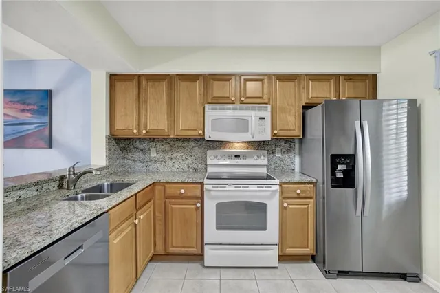 a kitchen with a stove sink and refrigerator