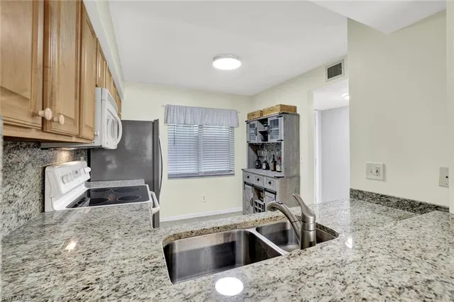 a kitchen with a sink and a stove top oven