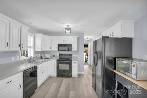 a kitchen with stainless steel appliances a refrigerator sink and stove
