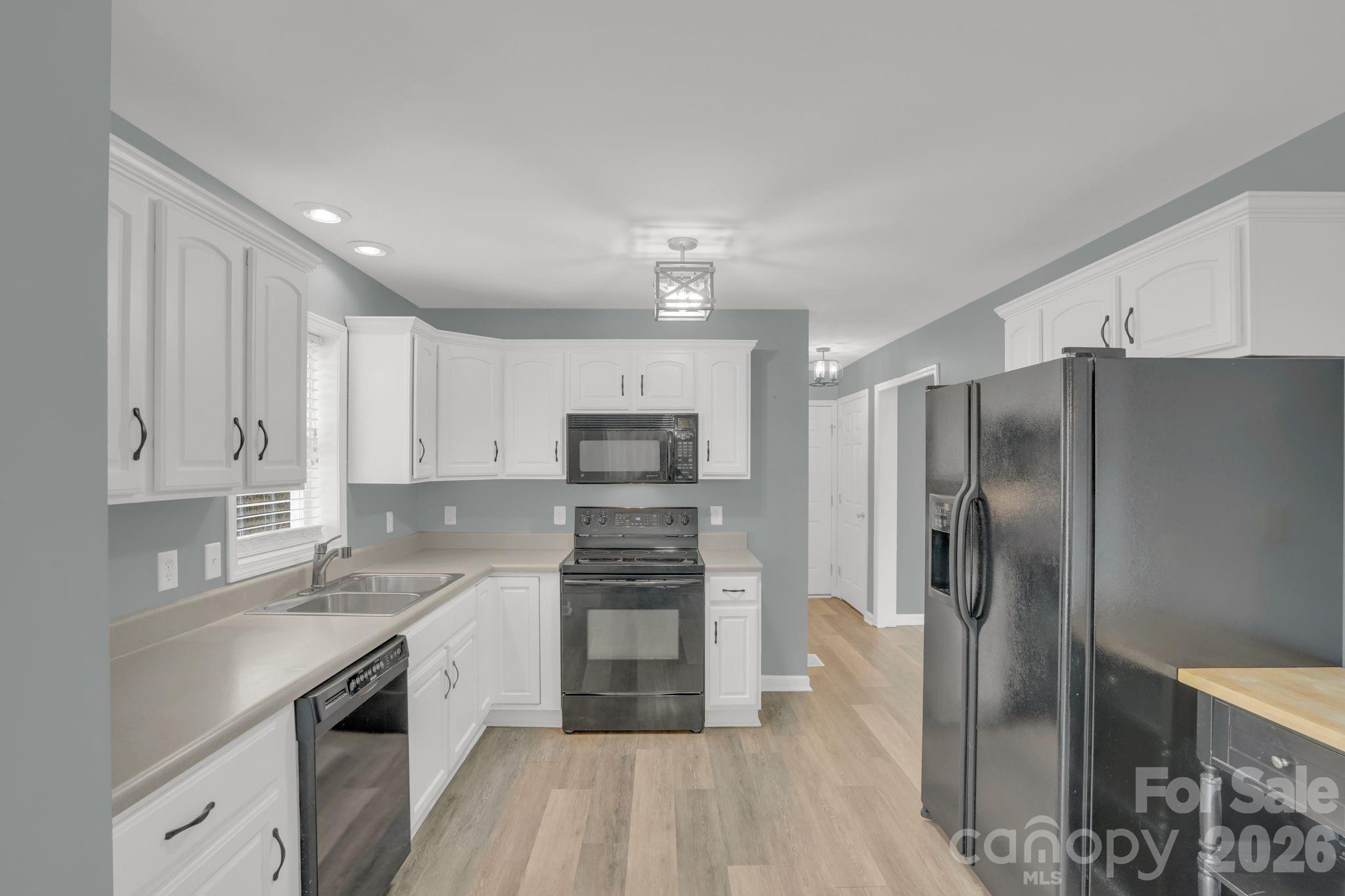 10425 Idlewild Road Matthews, NC 28105 - Photo 5 of 25 a kitchen with stainless steel appliances a refrigerator sink and microwave