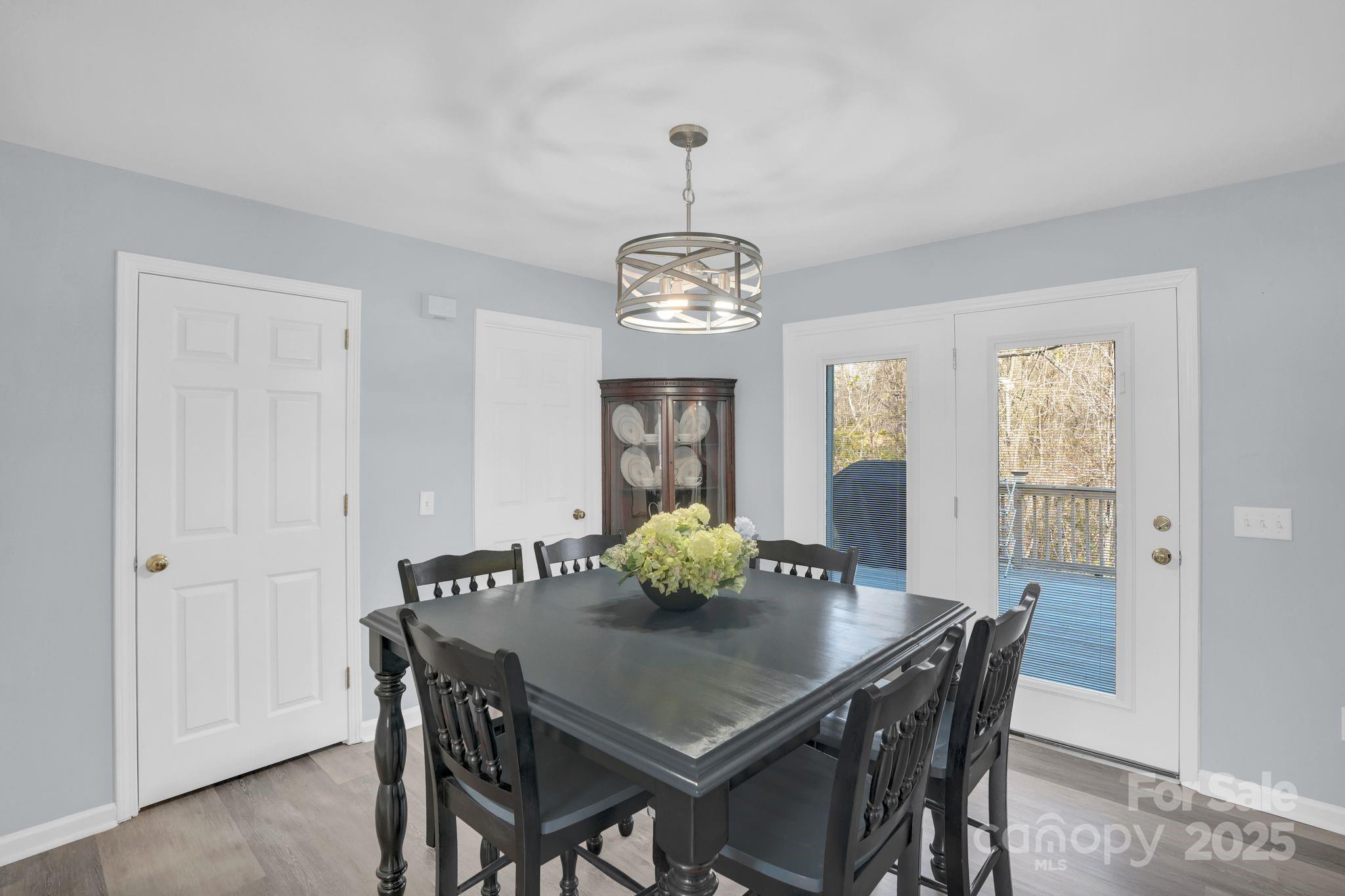 10425 Idlewild Road Matthews, NC 28105 - Photo 5 of 23 a view of a dining room with furniture and wooden floor