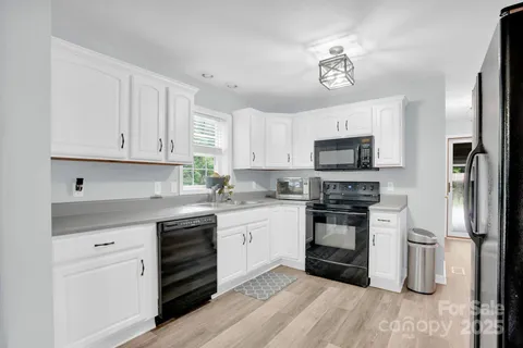 a kitchen with a sink stainless steel appliances and cabinets