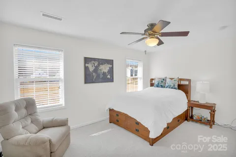 a bedroom with a bed couch and window