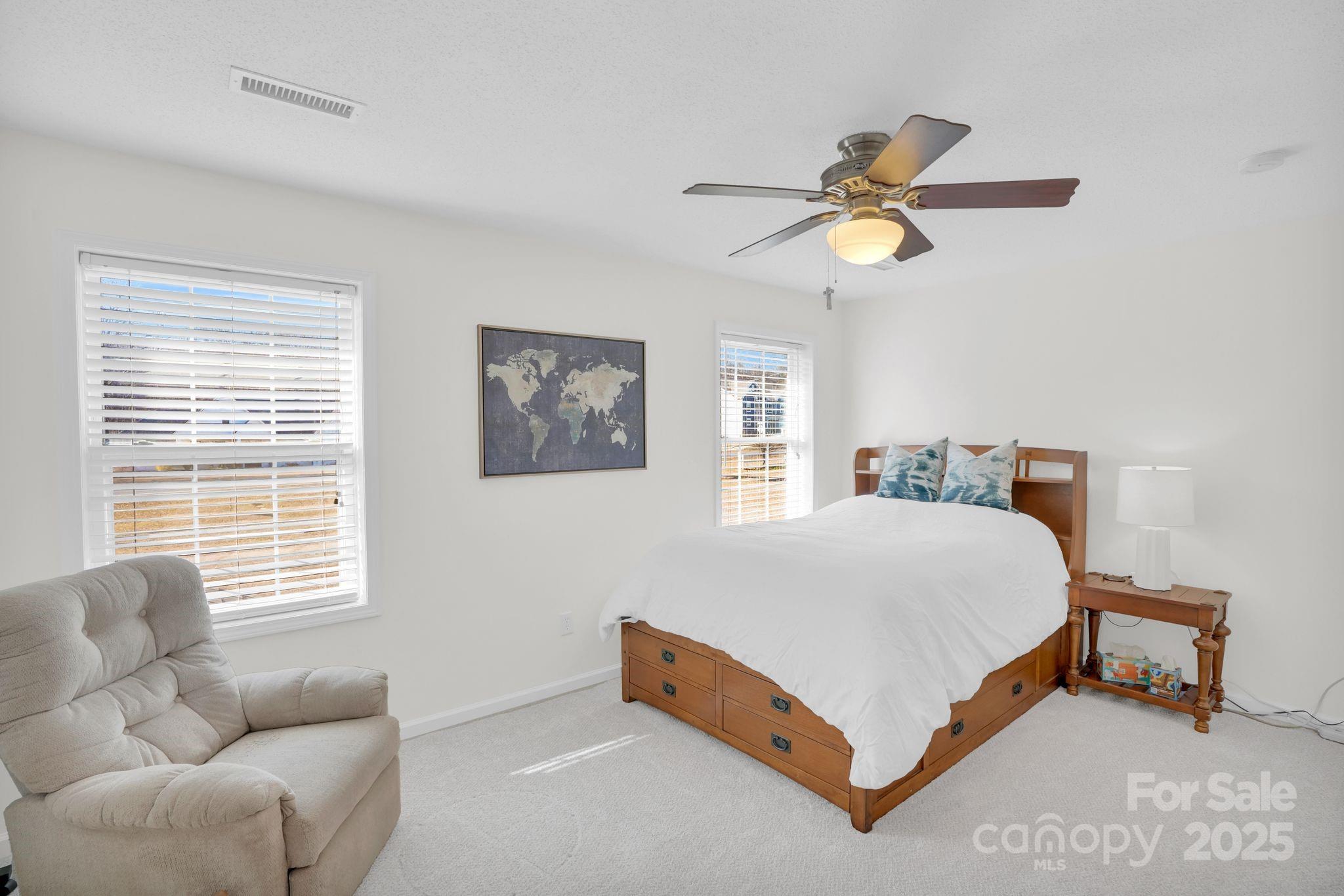 10425 Idlewild Road Matthews, NC 28105 - Photo 9 of 23 a bedroom with a bed couch and window