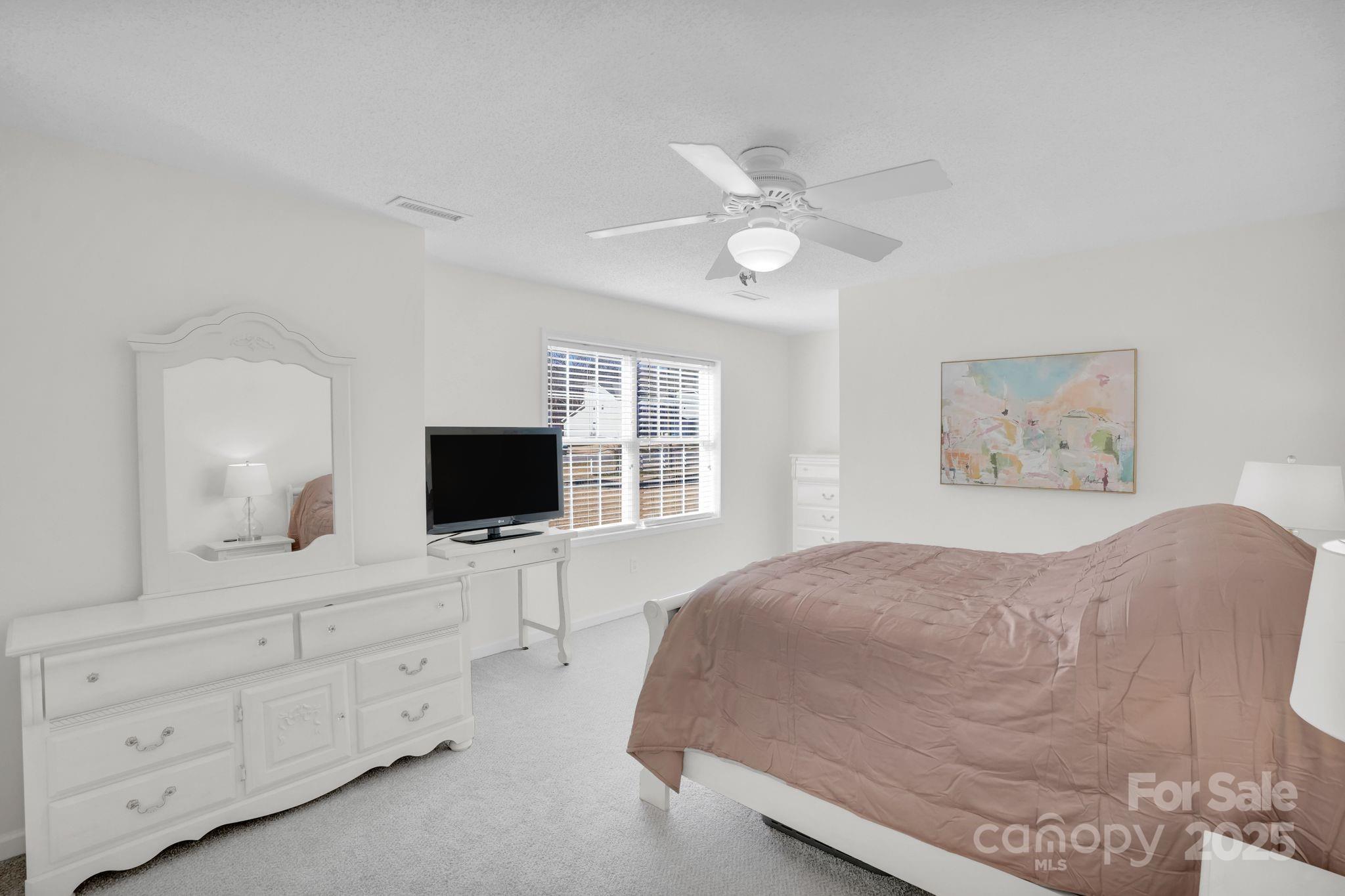 10425 Idlewild Road Matthews, NC 28105 - Photo 10 of 23 a living room with furniture and a flat screen tv