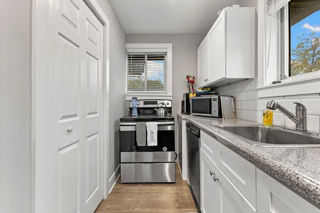 a kitchen with a refrigerator and a sink