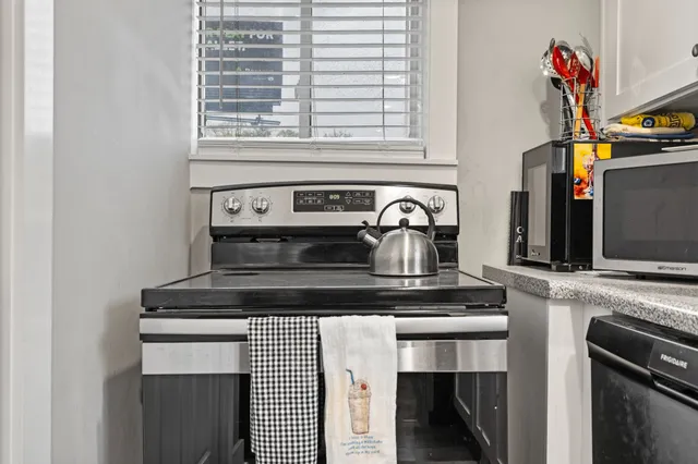 a kitchen with a stove and a microwave
