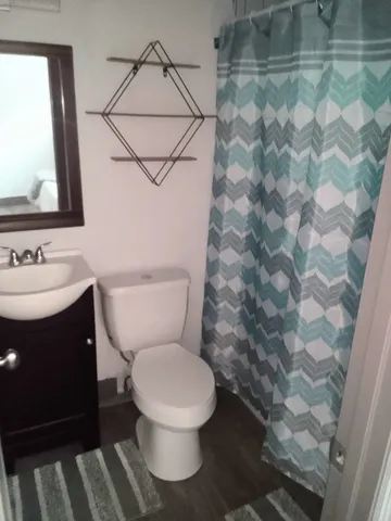 a white toilet sitting next to a bathroom sink