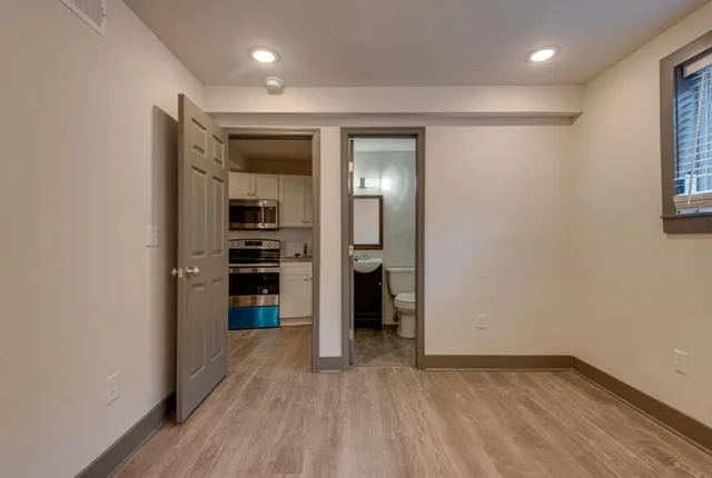 an empty room with closet and wooden floor