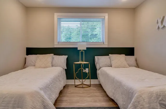 a bed room with a bed and a night stand