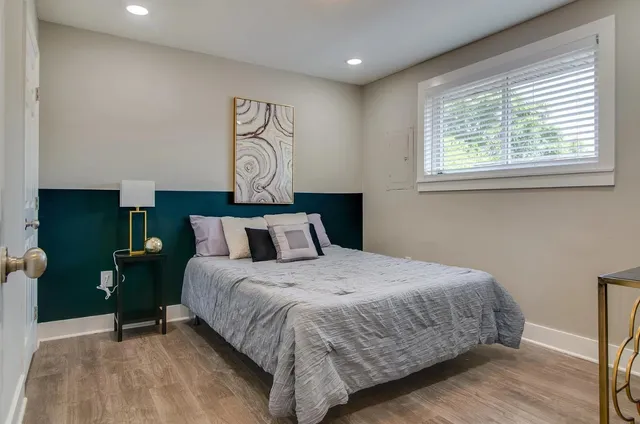 a bedroom with bed and window