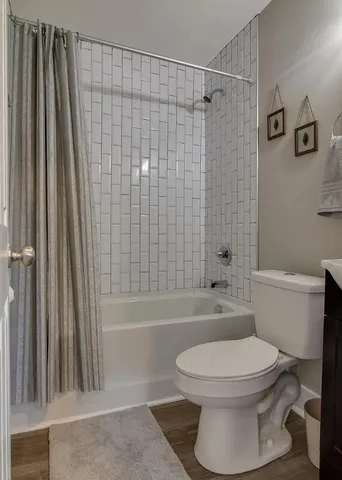 a bathroom with a toilet a sink and shower
