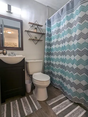 a bathroom with a sink toilet and shower