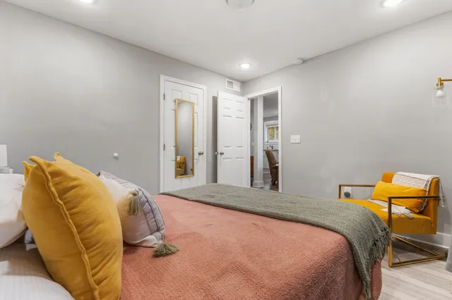 a bedroom with a bed and chair