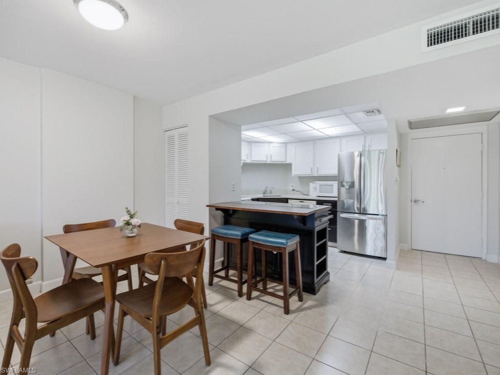 3 Bluebill Avenue, Unit 206 Naples, FL 34108 - Photo 6 of 19 a view of a dining room that has a table and chairs in it