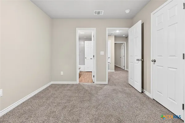 en empty room with an entrance to other room