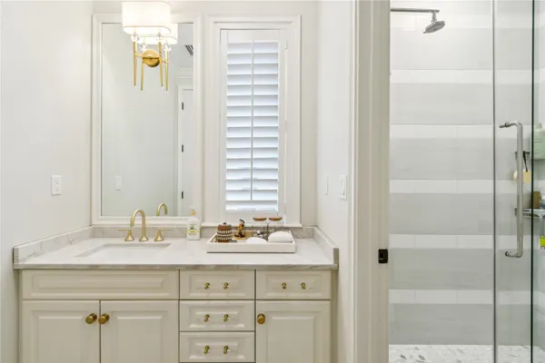 a bathroom with a granite countertop sink mirror and