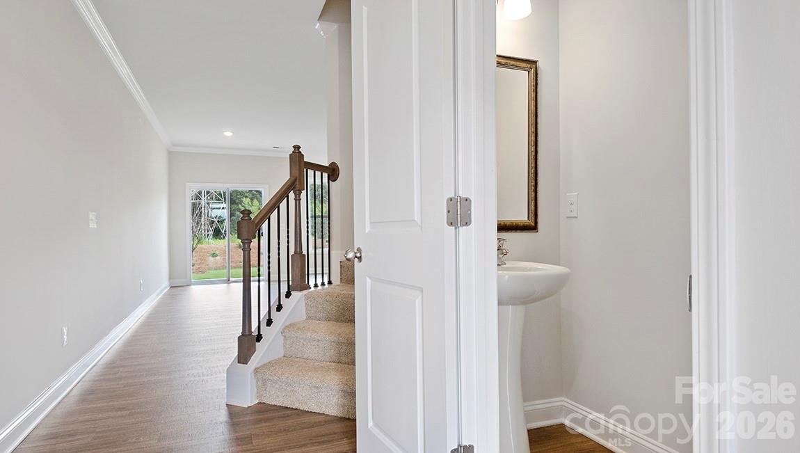384 Creekview Road Hendersonville, NC 28792 - Photo 13 of 22 a view of a hallway with wooden floor and staircase