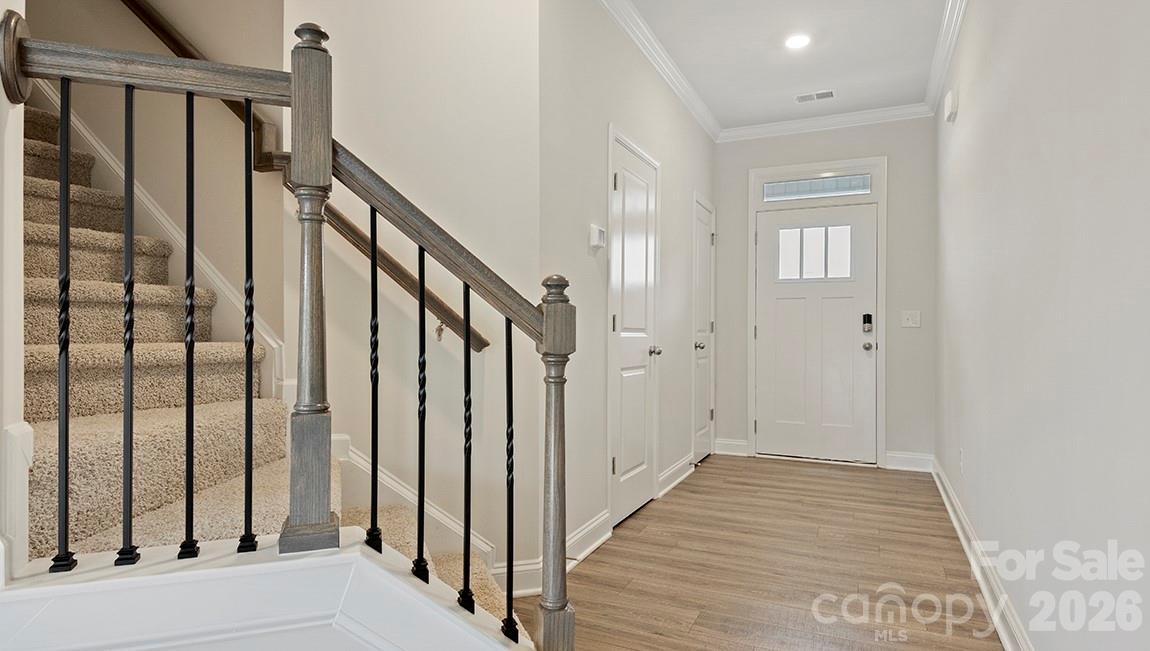 384 Creekview Road Hendersonville, NC 28792 - Photo 14 of 22 a view of a hallway with wooden floor and staircase