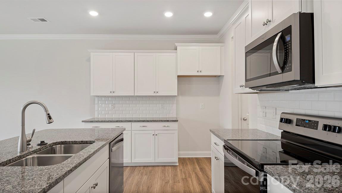 384 Creekview Road Hendersonville, NC 28792 - Photo 6 of 22 a kitchen with stainless steel appliances granite countertop a sink stove and microwave