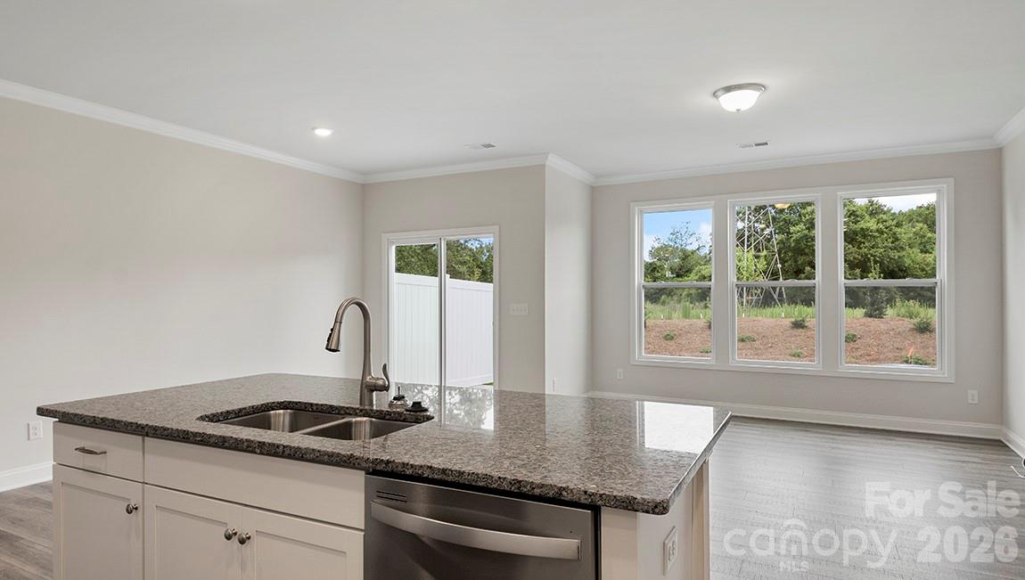 384 Creekview Road Hendersonville, NC 28792 - Photo 7 of 22 a kitchen with granite countertop a stove and a sink