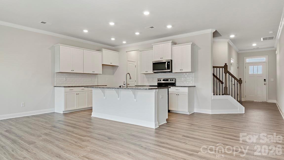 384 Creekview Road Hendersonville, NC 28792 - Photo 9 of 22 a kitchen with granite countertop a stove a sink and a refrigerator