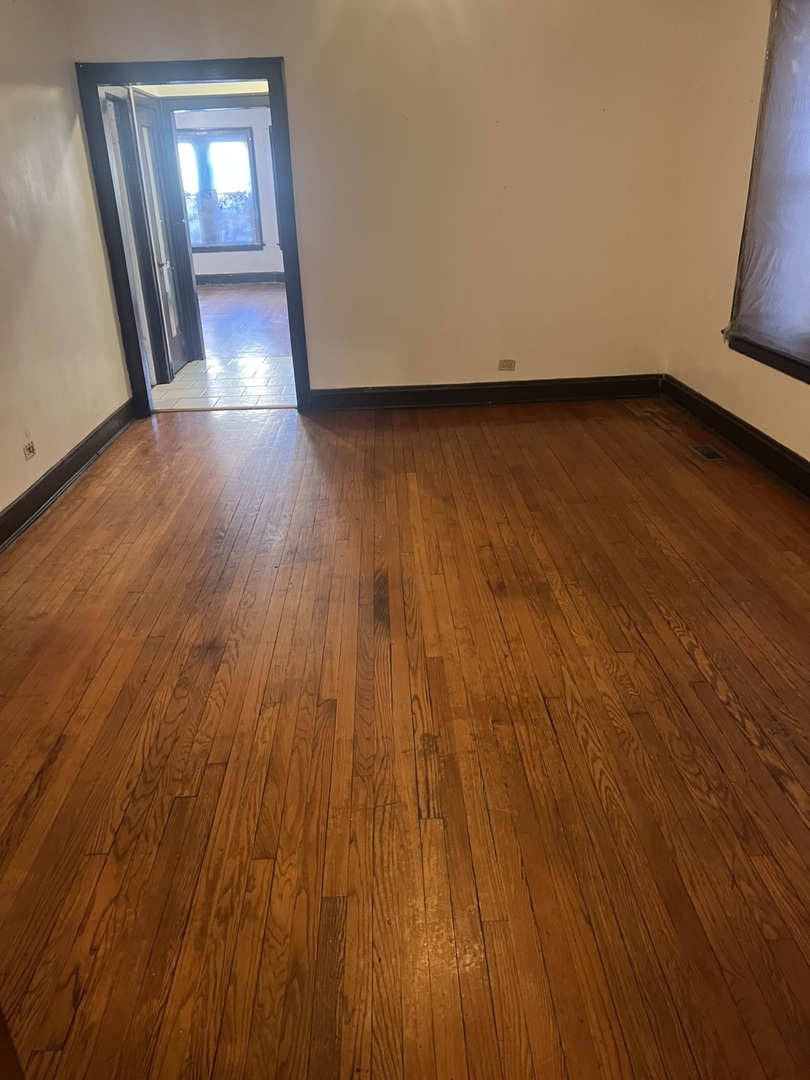 8010 South Evans Avenue, Unit 1 Chicago, IL 60619 - Photo 12 of 13 a view of a room with wooden floor and staircase