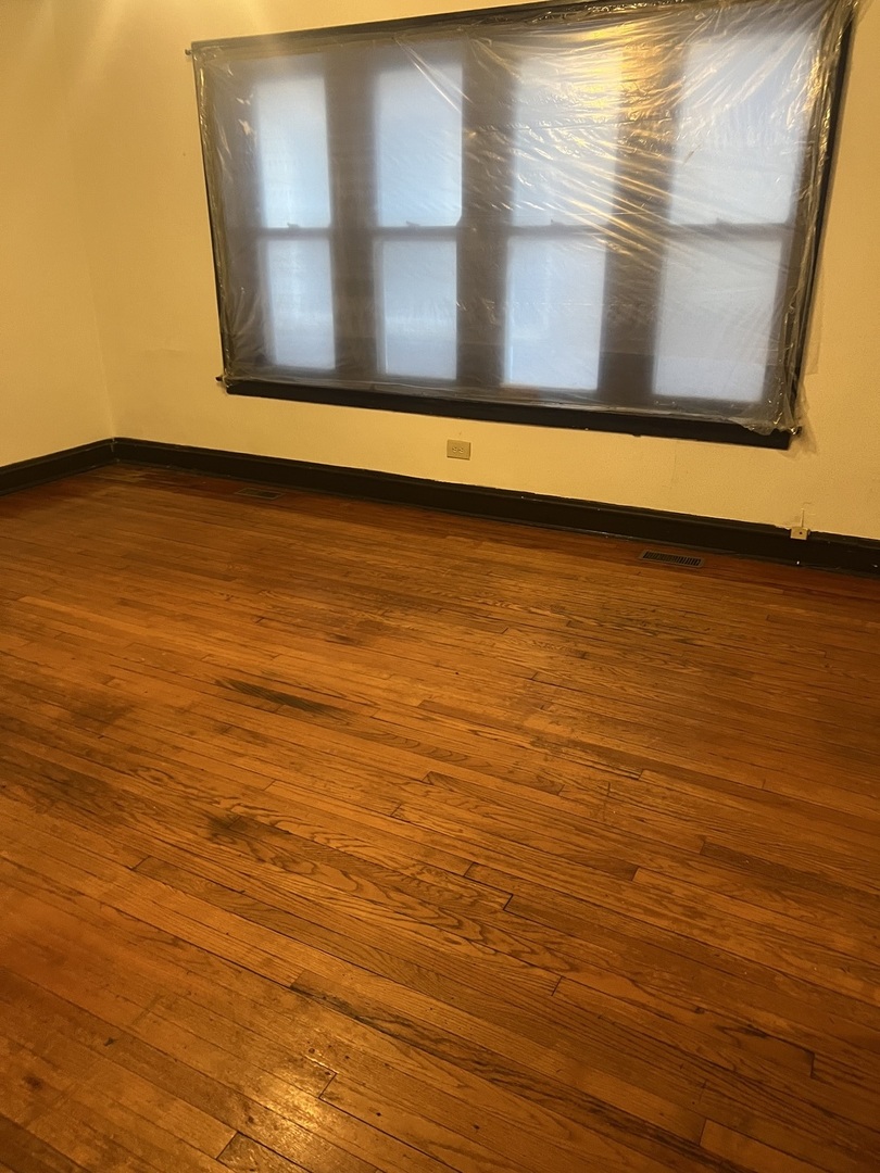 8010 South Evans Avenue, Unit 1 Chicago, IL 60619 - Photo 4 of 13 a view of a room with wooden floor