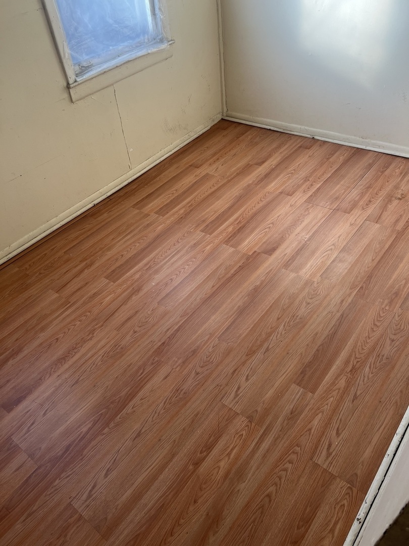 8010 South Evans Avenue, Unit 1 Chicago, IL 60619 - Photo 7 of 13 a view of empty room with wooden floor