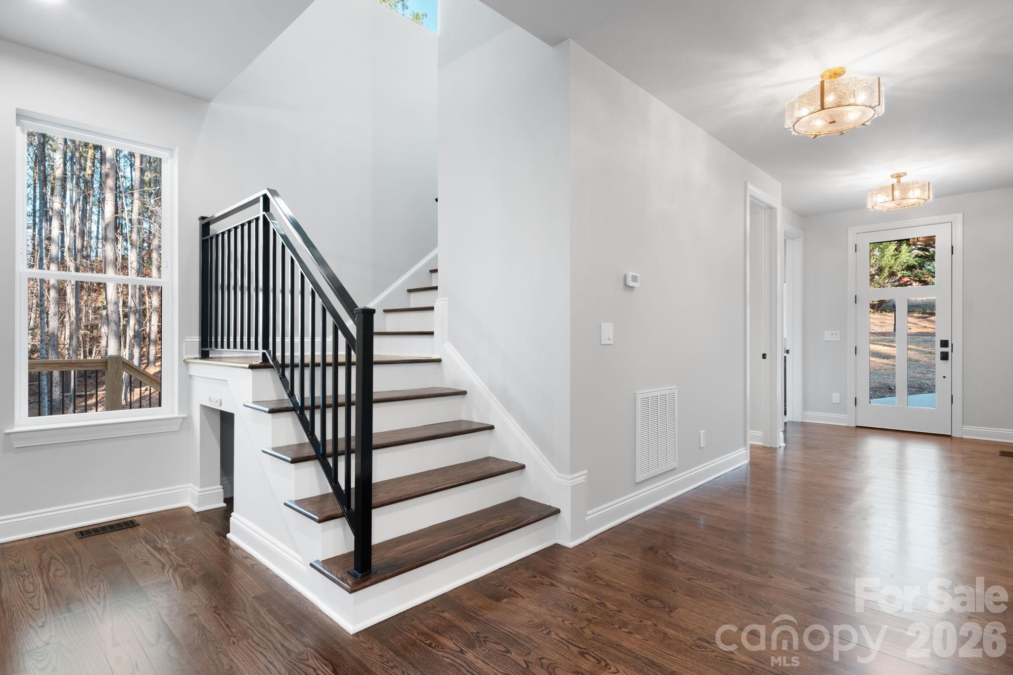 5163 Hurricane Hill Road Granite Falls, NC 28630 - Photo 12 of 40 a view of a hallway with wooden floor and staircase