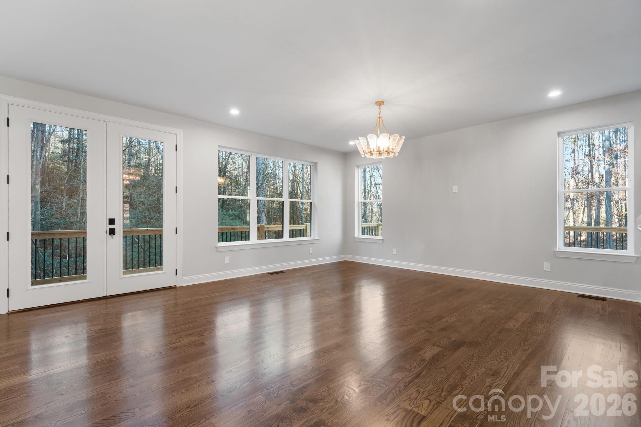 5163 Hurricane Hill Road Granite Falls, NC 28630 - Photo 15 of 40 a view of an empty room with wooden floor and a window