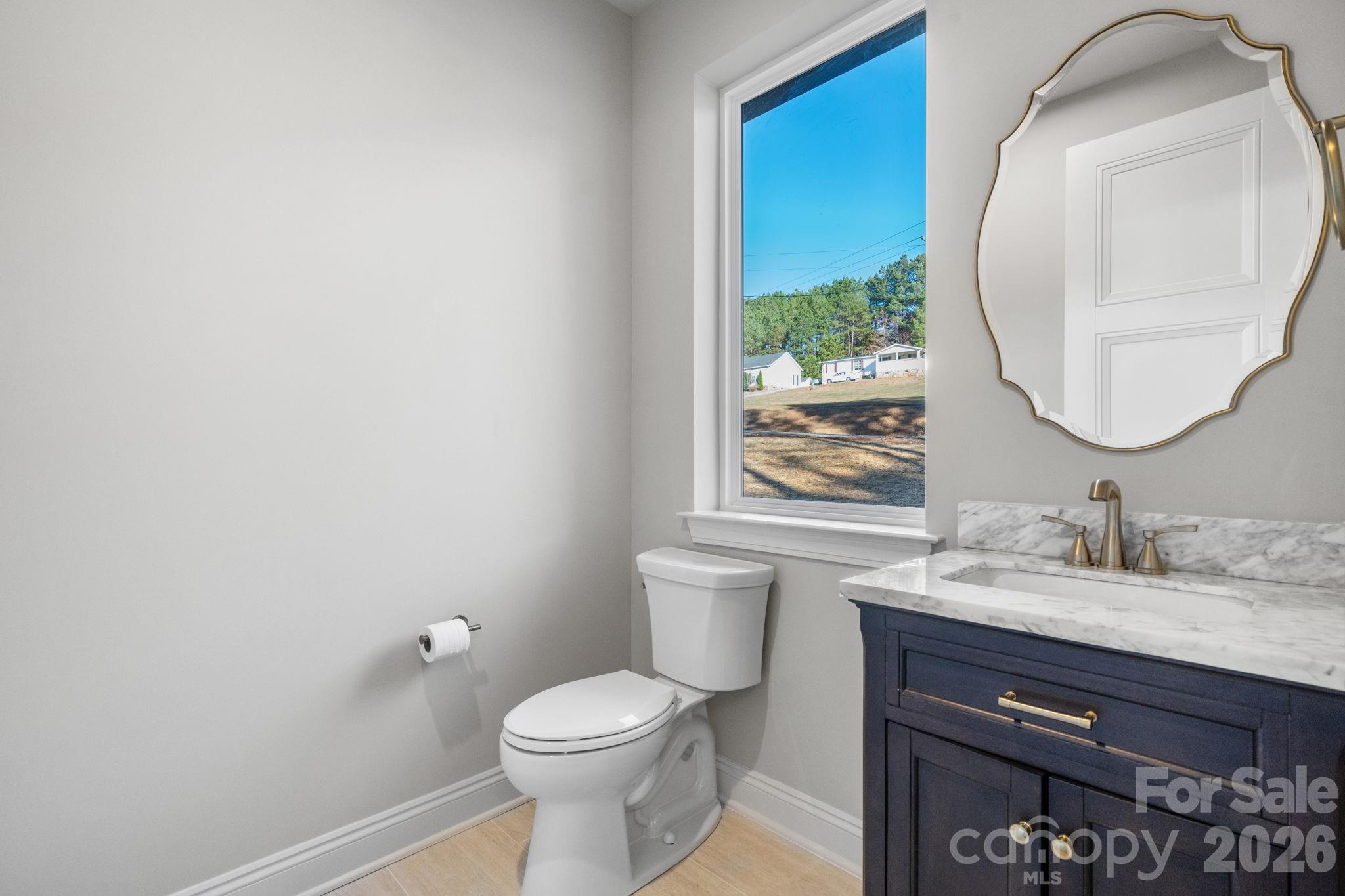 5163 Hurricane Hill Road Granite Falls, NC 28630 - Photo 16 of 40 a bathroom with a sink a toilet and a mirror
