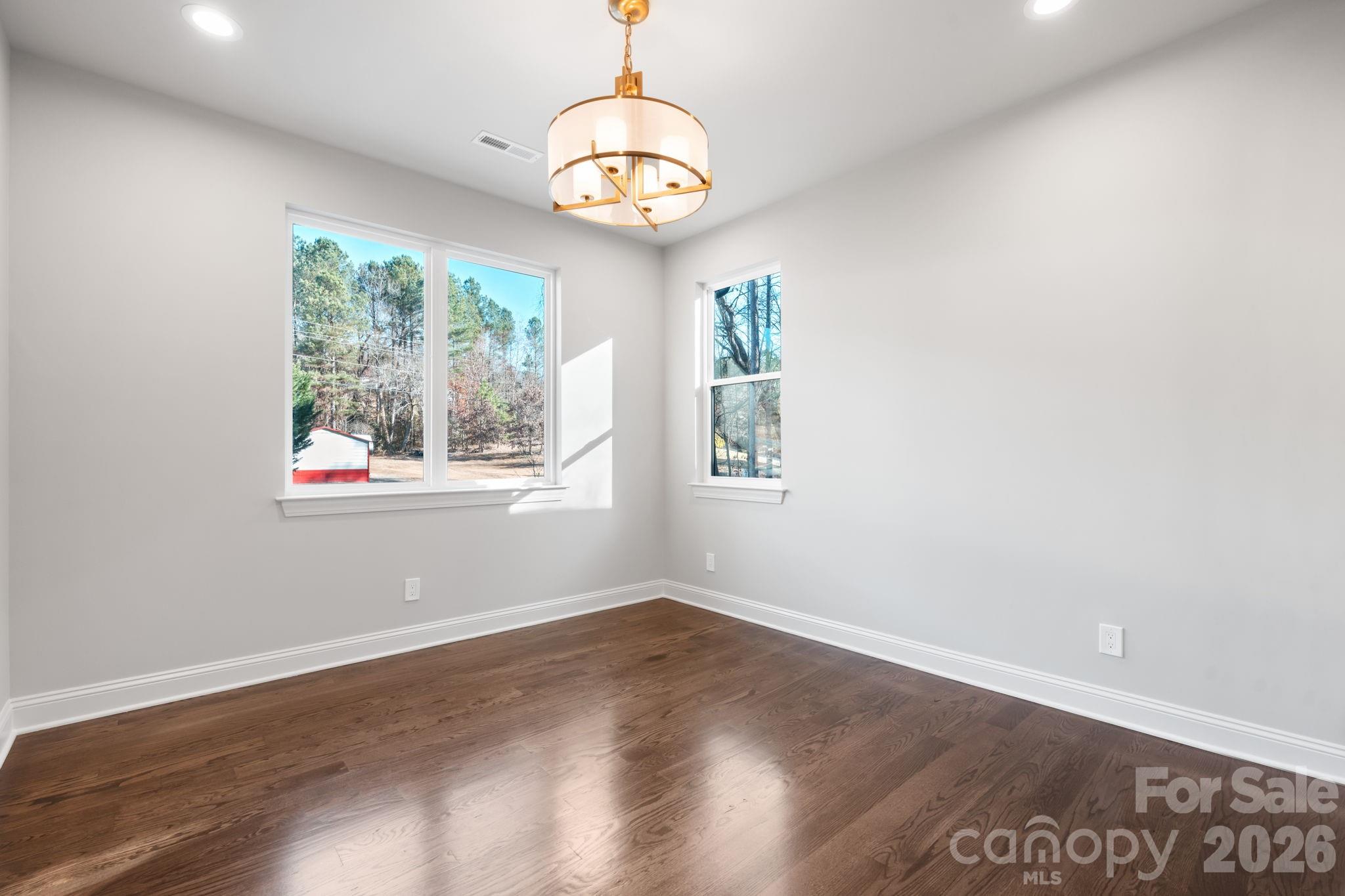 5163 Hurricane Hill Road Granite Falls, NC 28630 - Photo 23 of 40 an empty room with wooden floor and windows