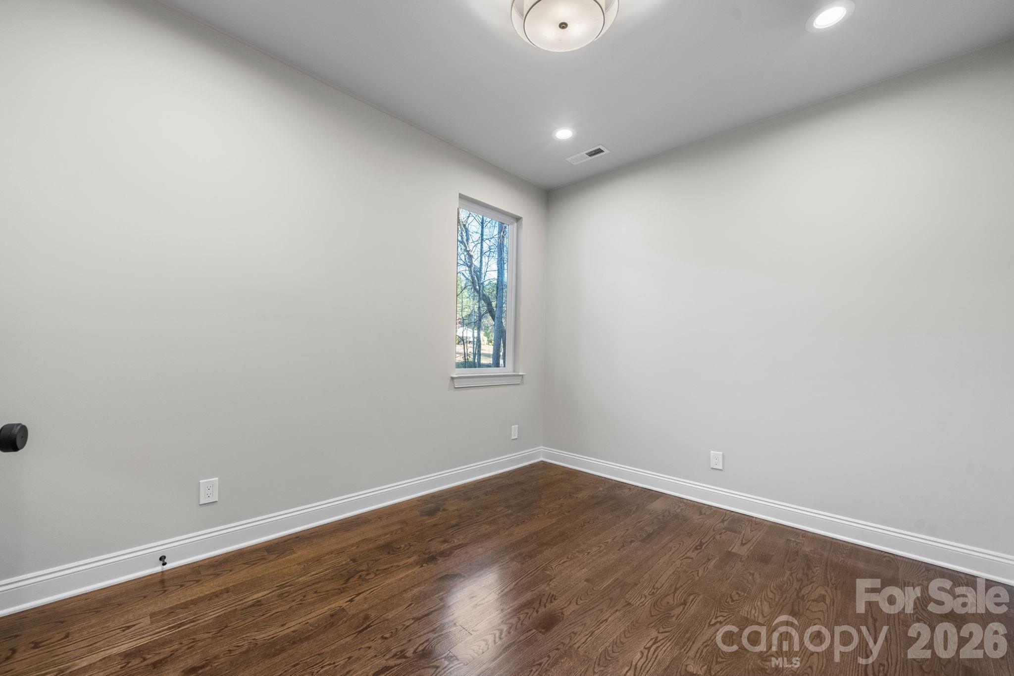 5163 Hurricane Hill Road Granite Falls, NC 28630 - Photo 24 of 40 an empty room with wooden floor and windows