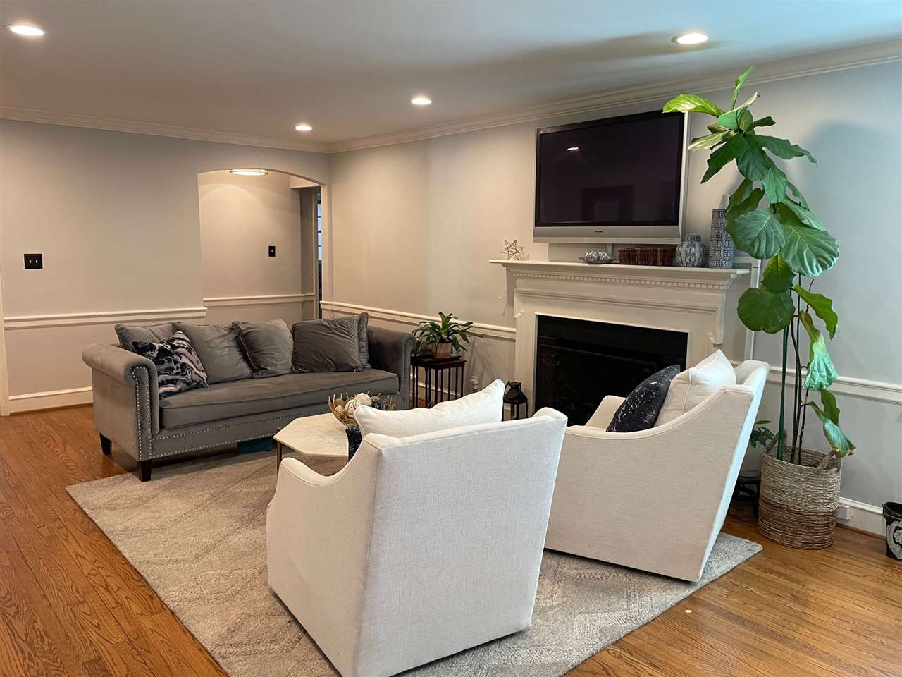 3613 Hathaway Road Durham, NC 27707 - Photo 11 of 24 a living room with furniture a fireplace and a flat screen tv