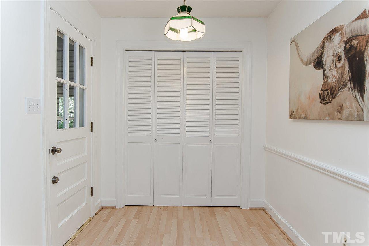 6412 Brandywine Road Raleigh, NC 27607 - Photo 11 of 25 an empty room with wooden floor and windows