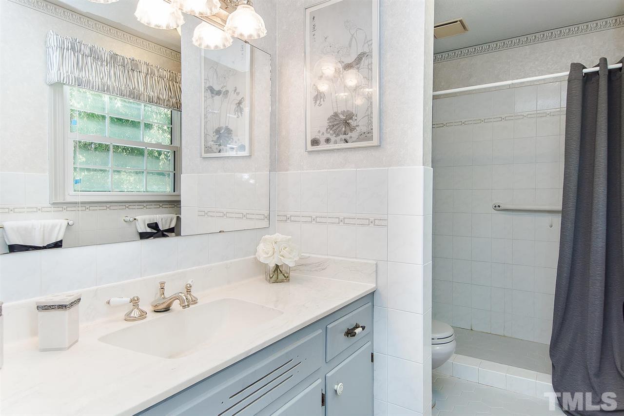 6412 Brandywine Road Raleigh, NC 27607 - Photo 16 of 25 a bathroom with a sink and a mirror