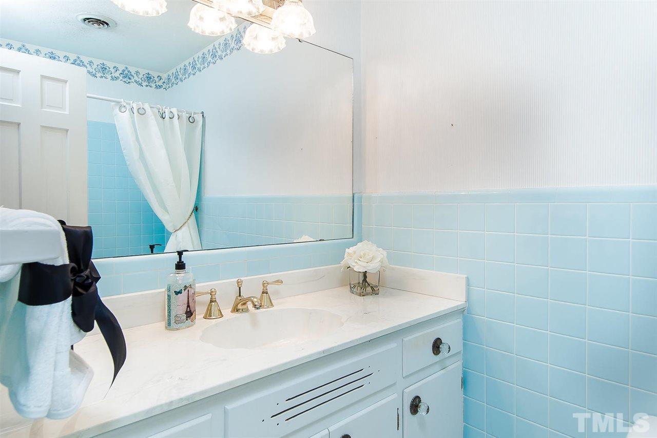 6412 Brandywine Road Raleigh, NC 27607 - Photo 18 of 25 a bathroom with a sink and a mirror
