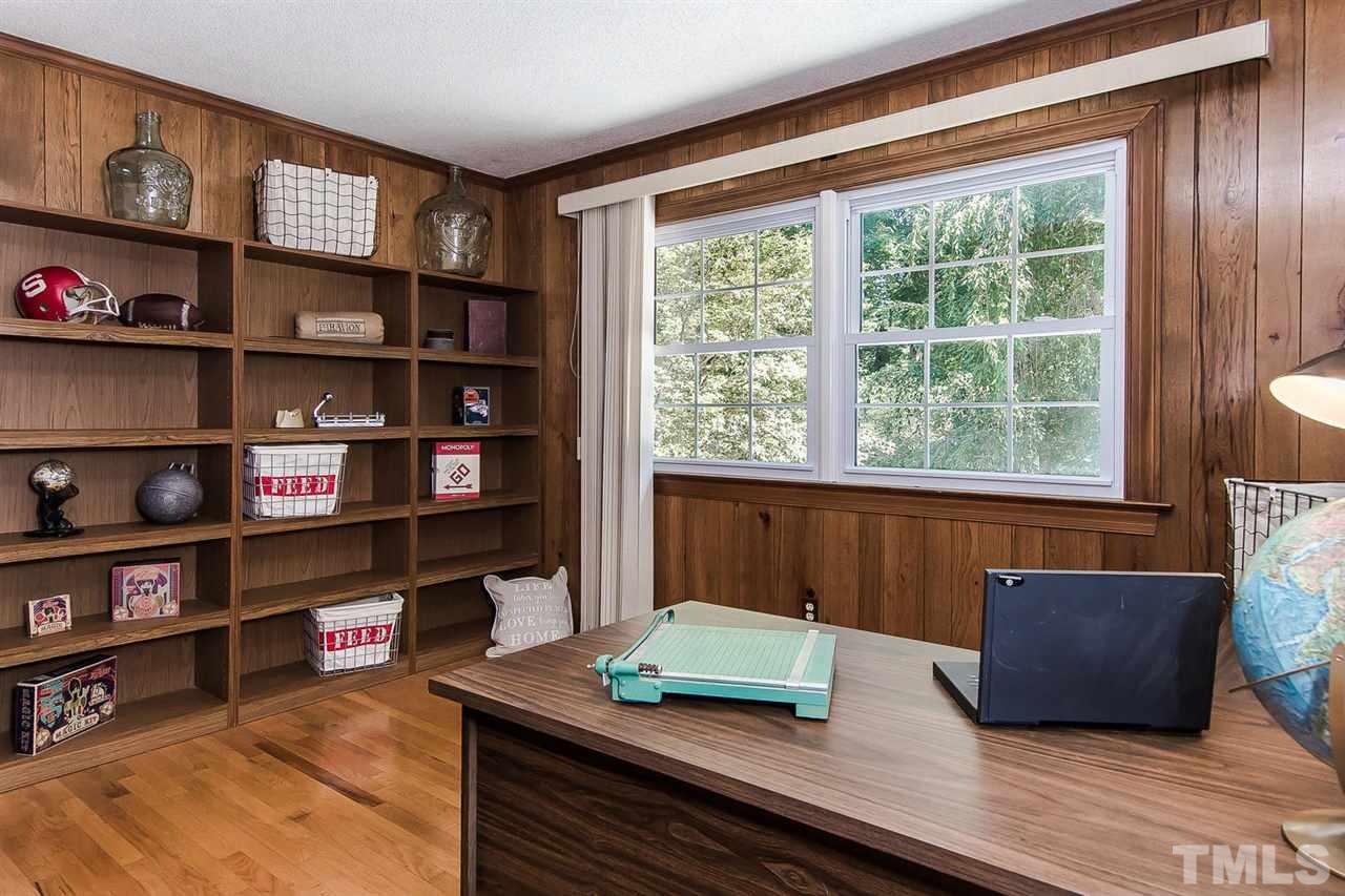 6412 Brandywine Road Raleigh, NC 27607 - Photo 20 of 25 a living room with furniture and a book shelf