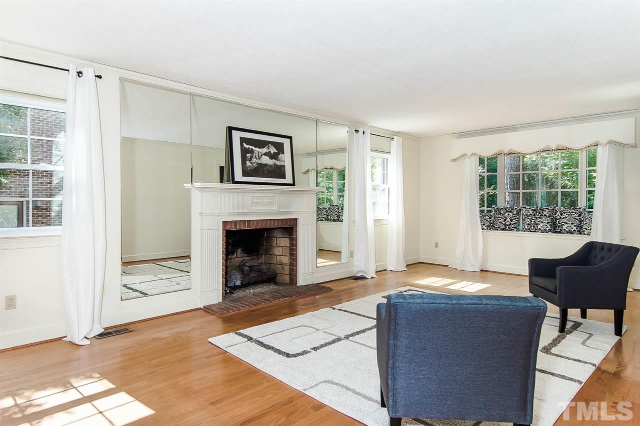 6412 Brandywine Road Raleigh, NC 27607 - Photo 7 of 25 a living room with furniture and a fireplace
