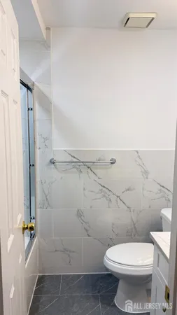 a white toilet sitting next to a bathroom sink